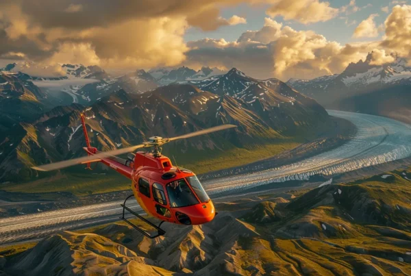 a breathtaking aerial view captures a colorful helicopter soaring above rugged mountain landscapes, showcasing the thrill and adventure awaiting passengers on seward helicopter tours.